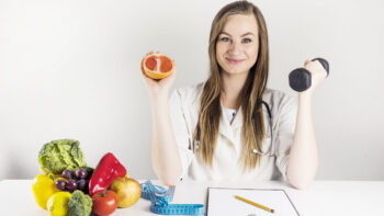 Muscle fibre types explained - woman training with a dumbbell, healthy food and a measuring tape