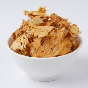 HealthyGrabz pineapple chips in a white bowl - air fried dehydrated pineapple fruit snack