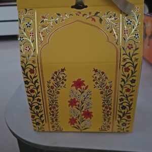 HealthyGrabz Diwali yellow gift bag with golden floral design and satin ribbon